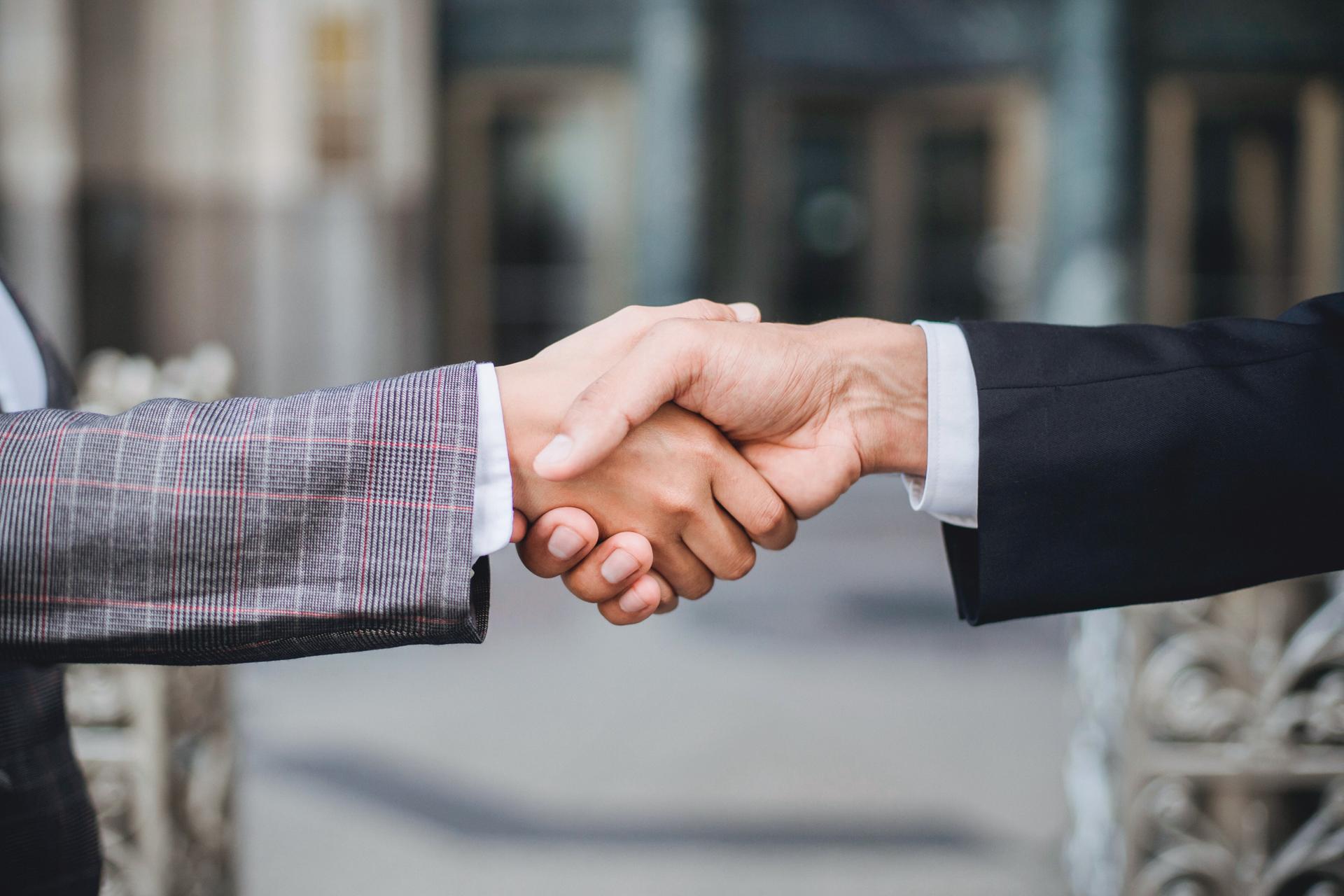 Focus shot of two people shaking hands