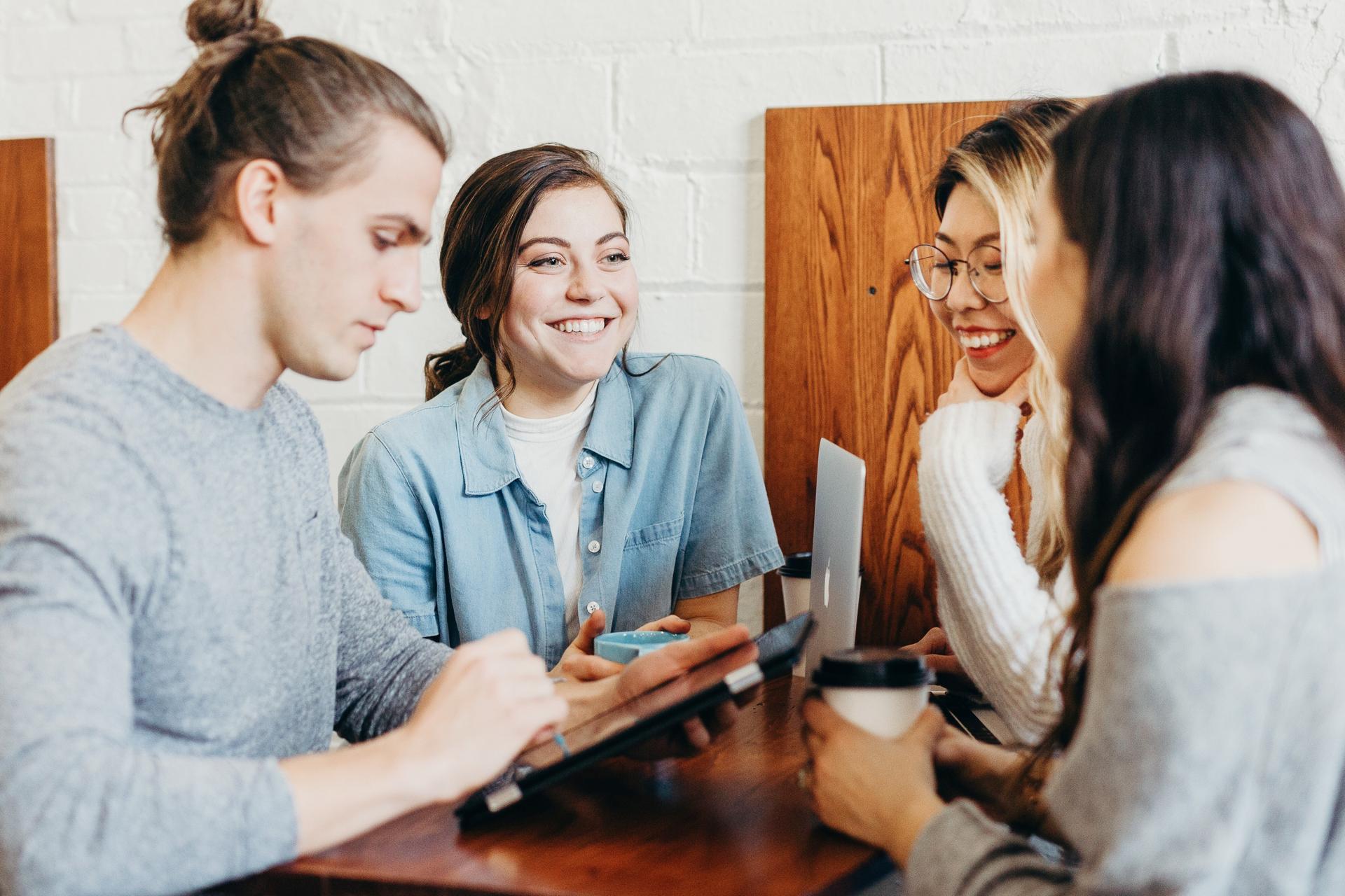 A group of 4 people having a coffee chat